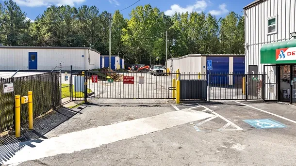 Secure gated entry to self storage facility with keypad access and fencing
